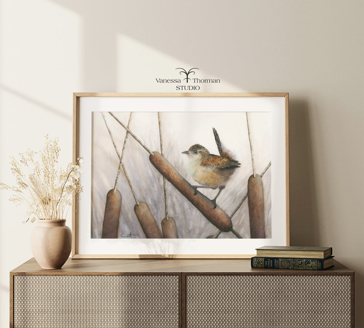 Framed Marsh Wren watercolor art print by Vanessa Thorman on a console table
