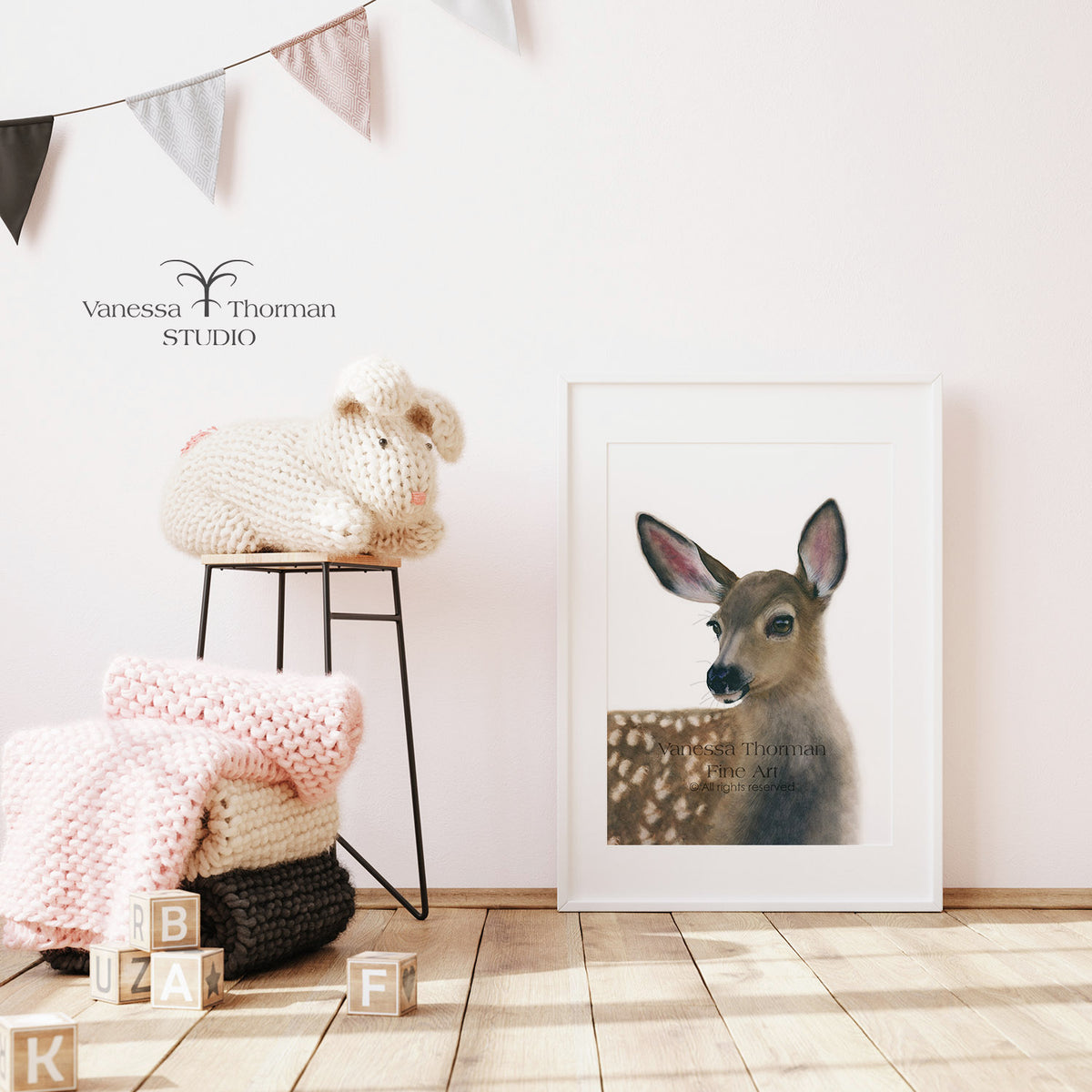 Framed White-Tailed Fawn watercolor art print by Vanessa Thorman displayed in a nursery