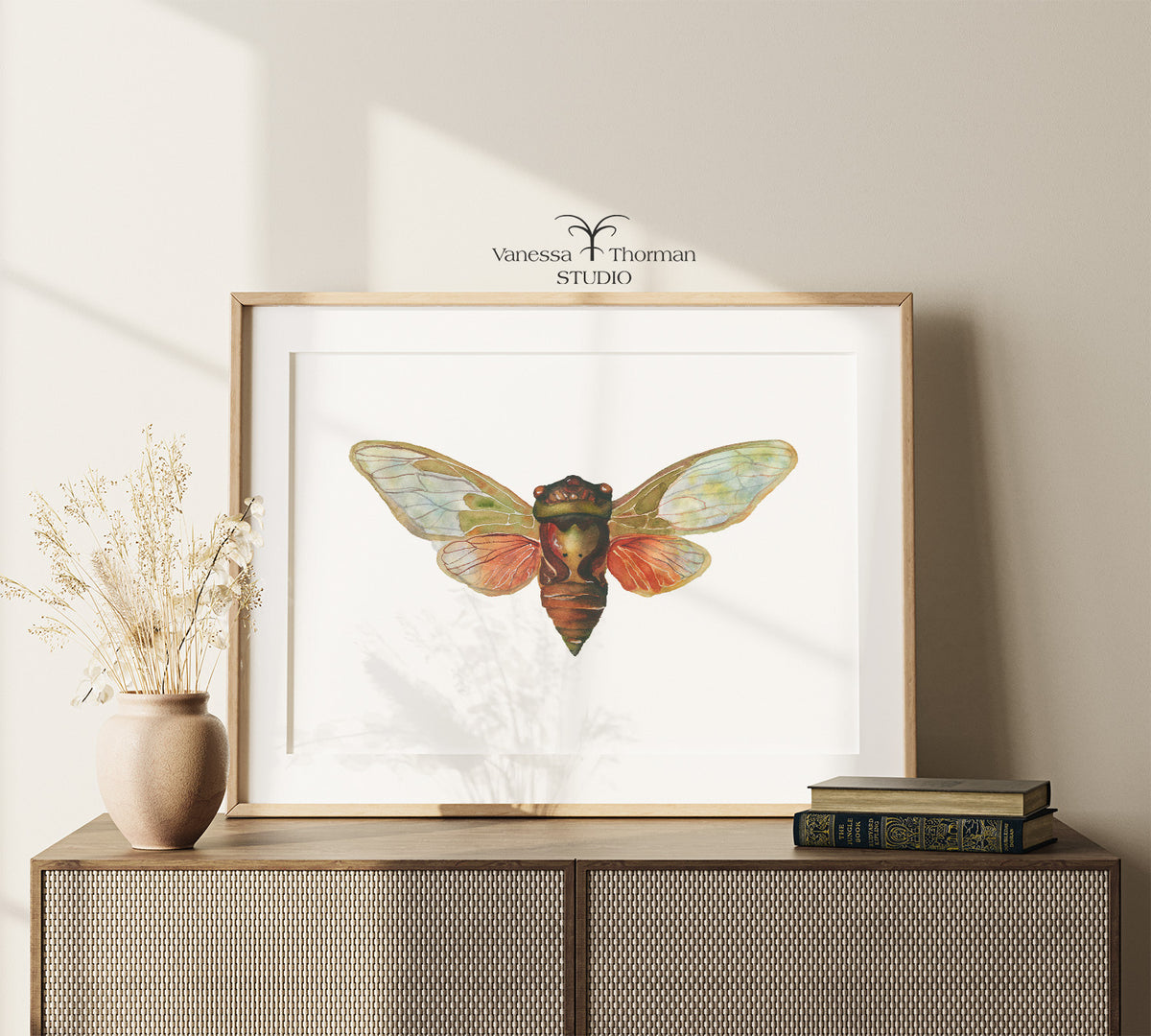Framed Cicada watercolor art print on a console table