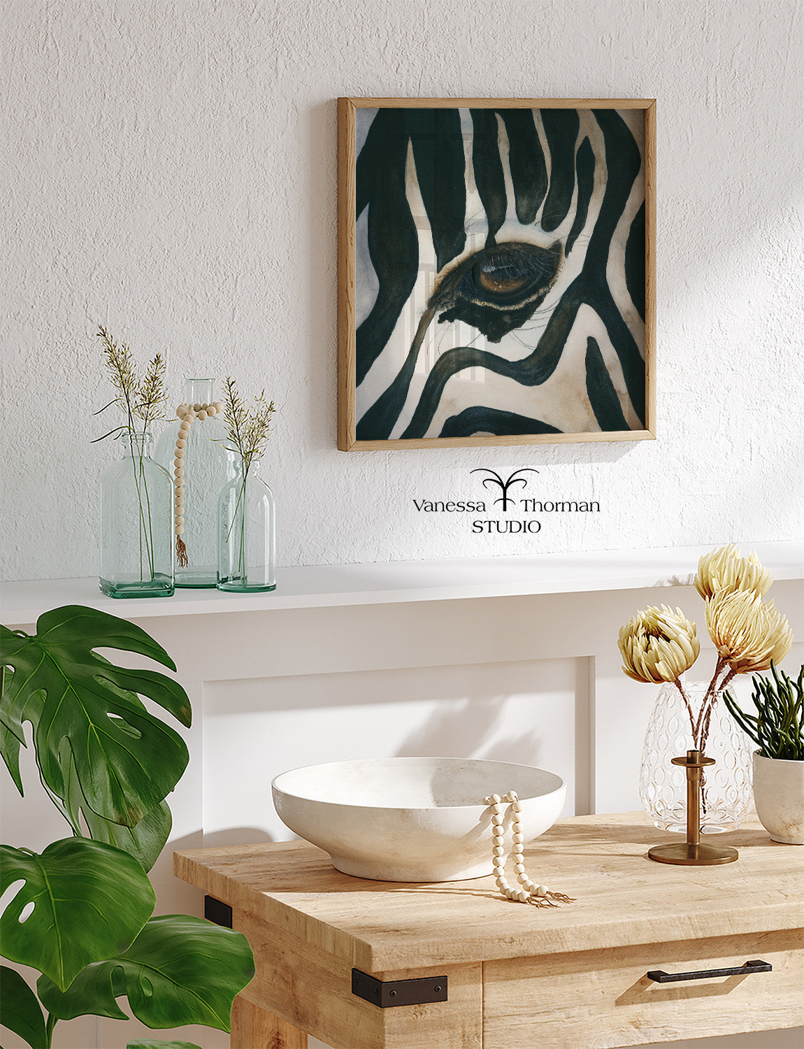 "Eye of the Storm" zebra eye watercolor art print by Vanessa Thorman hanging in a home
