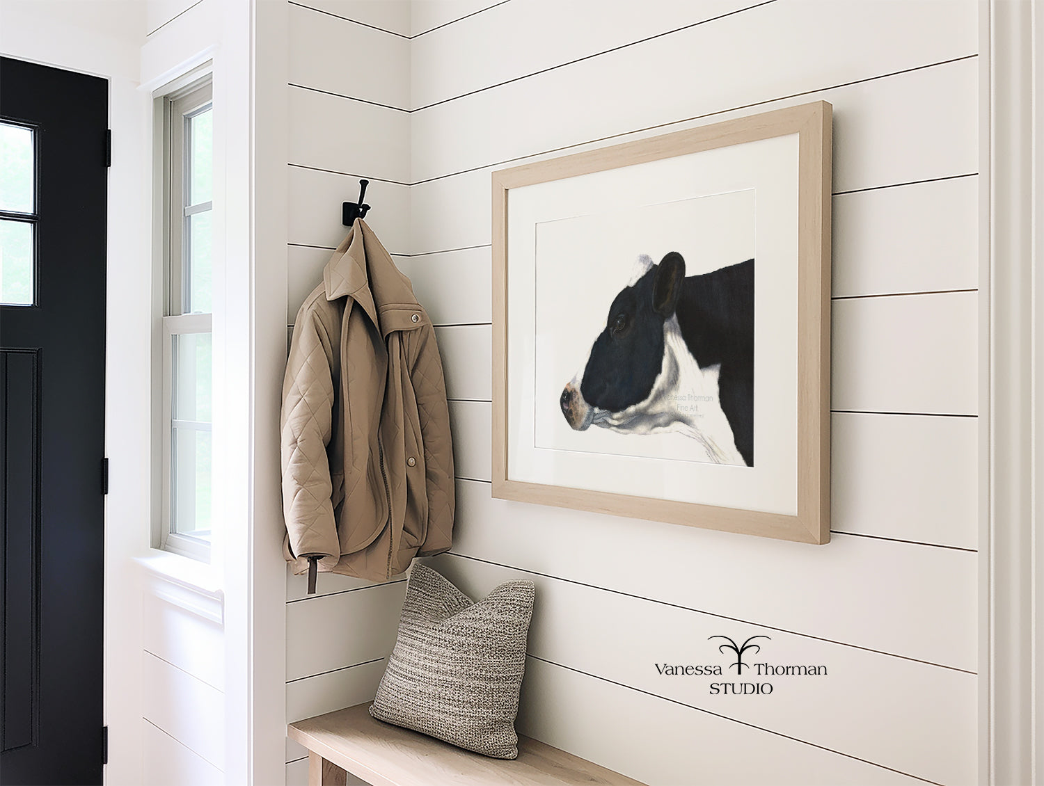 Framed Holstein Cow Watercolor art print on a white background hanging in an entry 