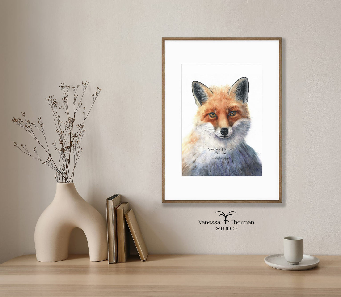 Framed "Italian Fox Portrait" watercolor art print by Vanessa Thorman above a console table.