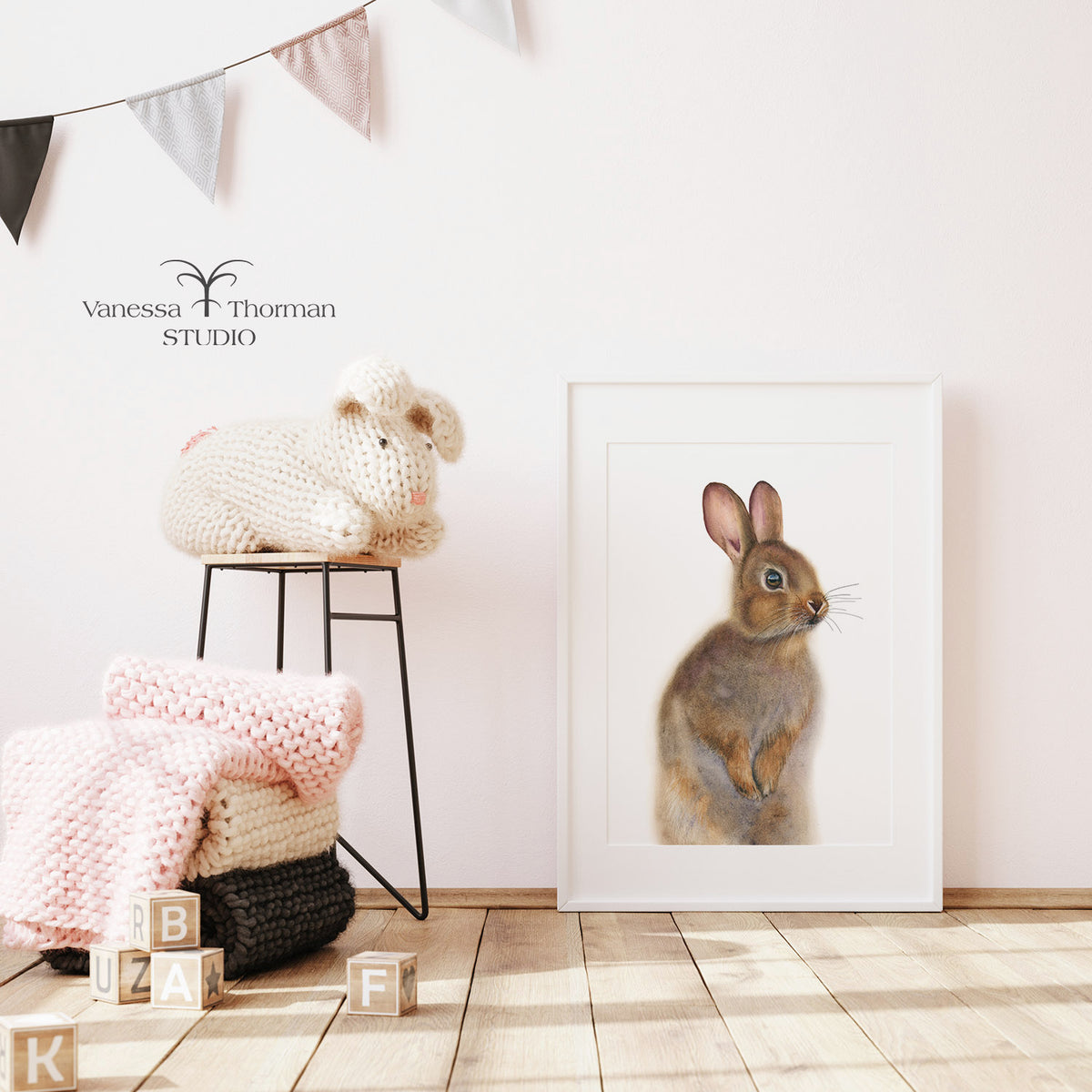 Framed "Nutmeg the Bunny" watercolor art print by Vanessa Thorman in a nursery