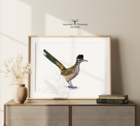 Framed Roadrunner watercolor art print by Vanessa Thorman on a console table