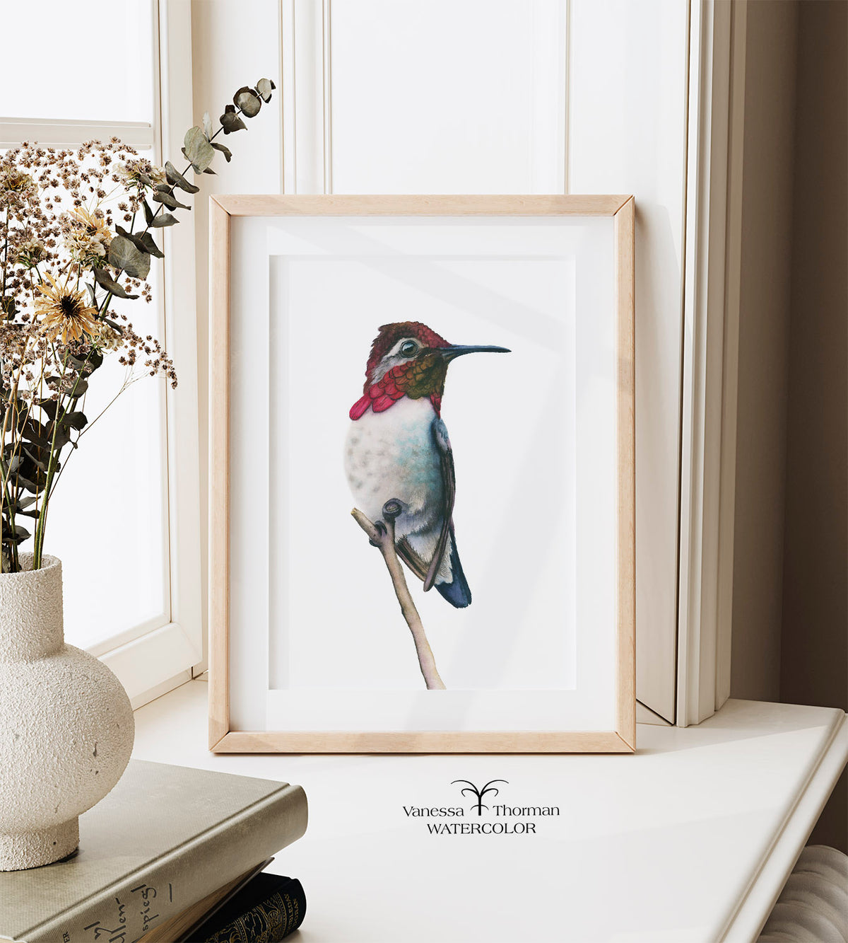 Framed "Bee Hummingbird 2" watercolor art print by Vanessa Thorman displayed on a windowsill