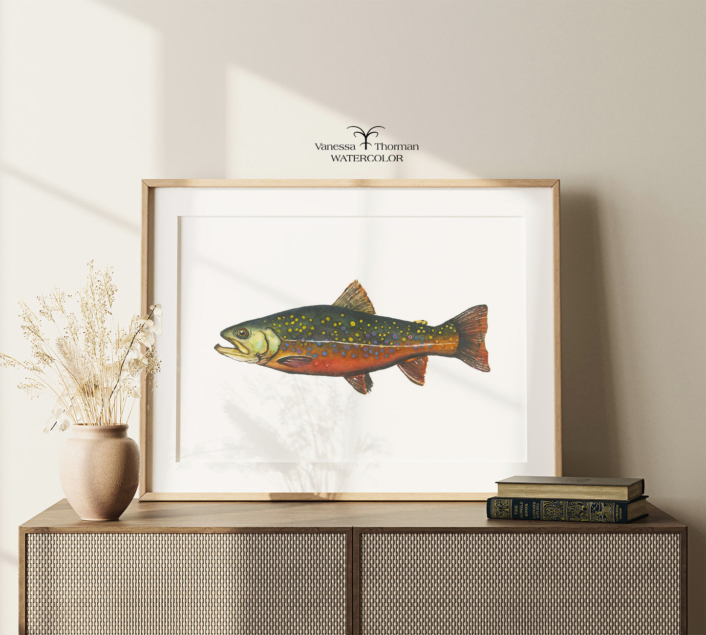 Framed Brook Trout watercolor art print displayed on a console table