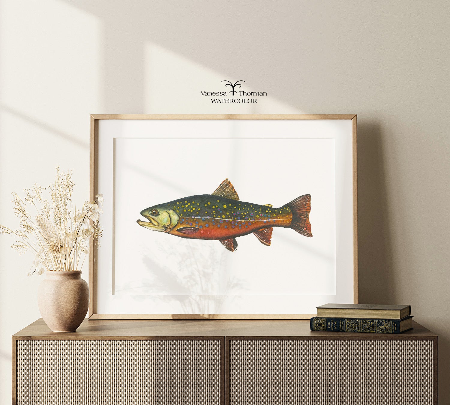 Framed Brook Trout watercolor art print displayed on a console table