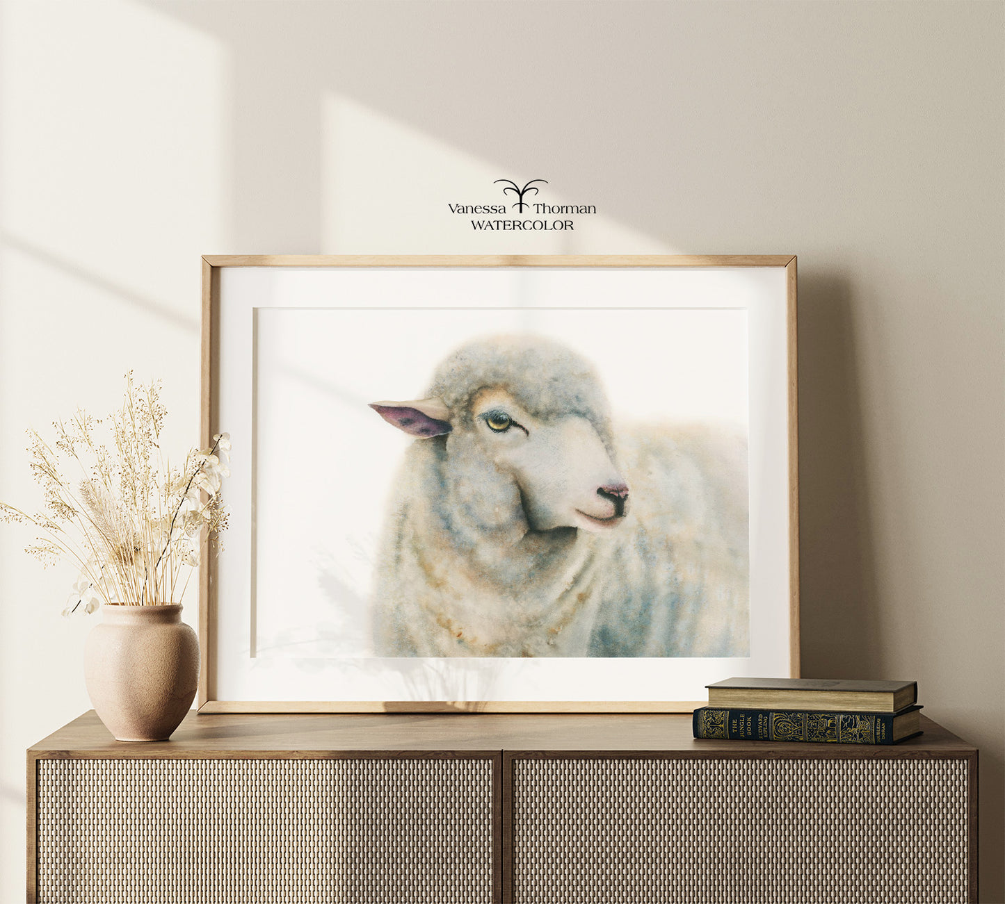 Framed "Duchess" sheep watercolor art print displayed on a console table