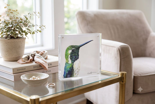 Vincent the green hummingbird acrylic block art print displayed on an end table