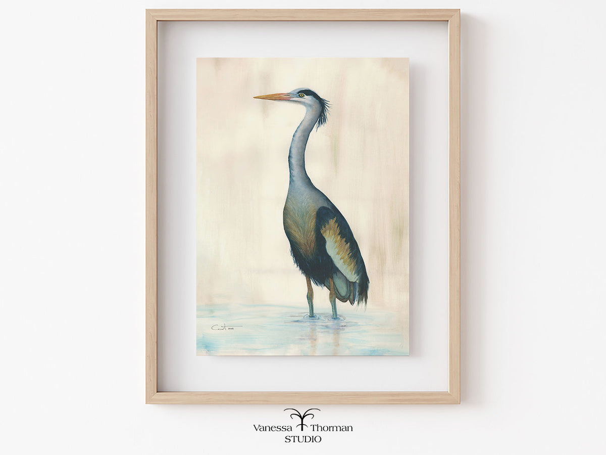 Framed "Marsh Heron in Blue" watercolor art print on a light background by Vanessa Thorman