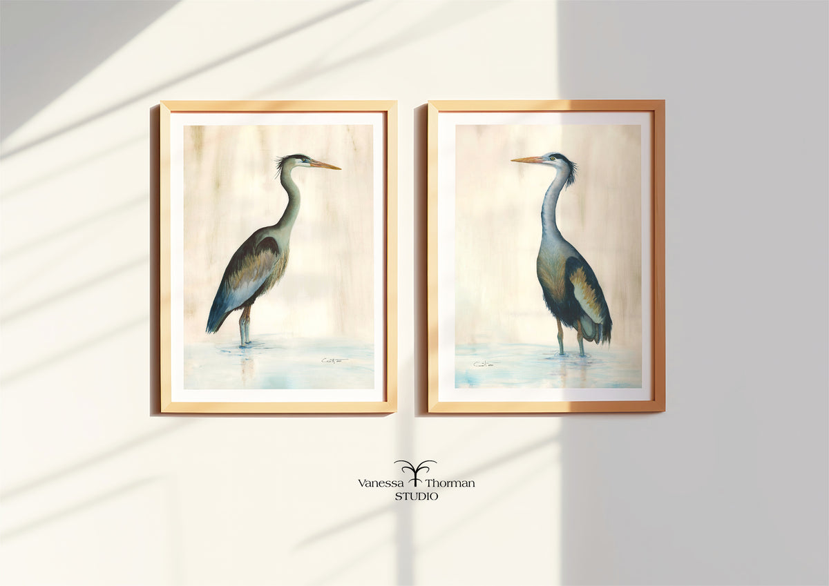 Two framed heron watercolor art prints displayed together on a wall, including "Marsh Heron in Green" 