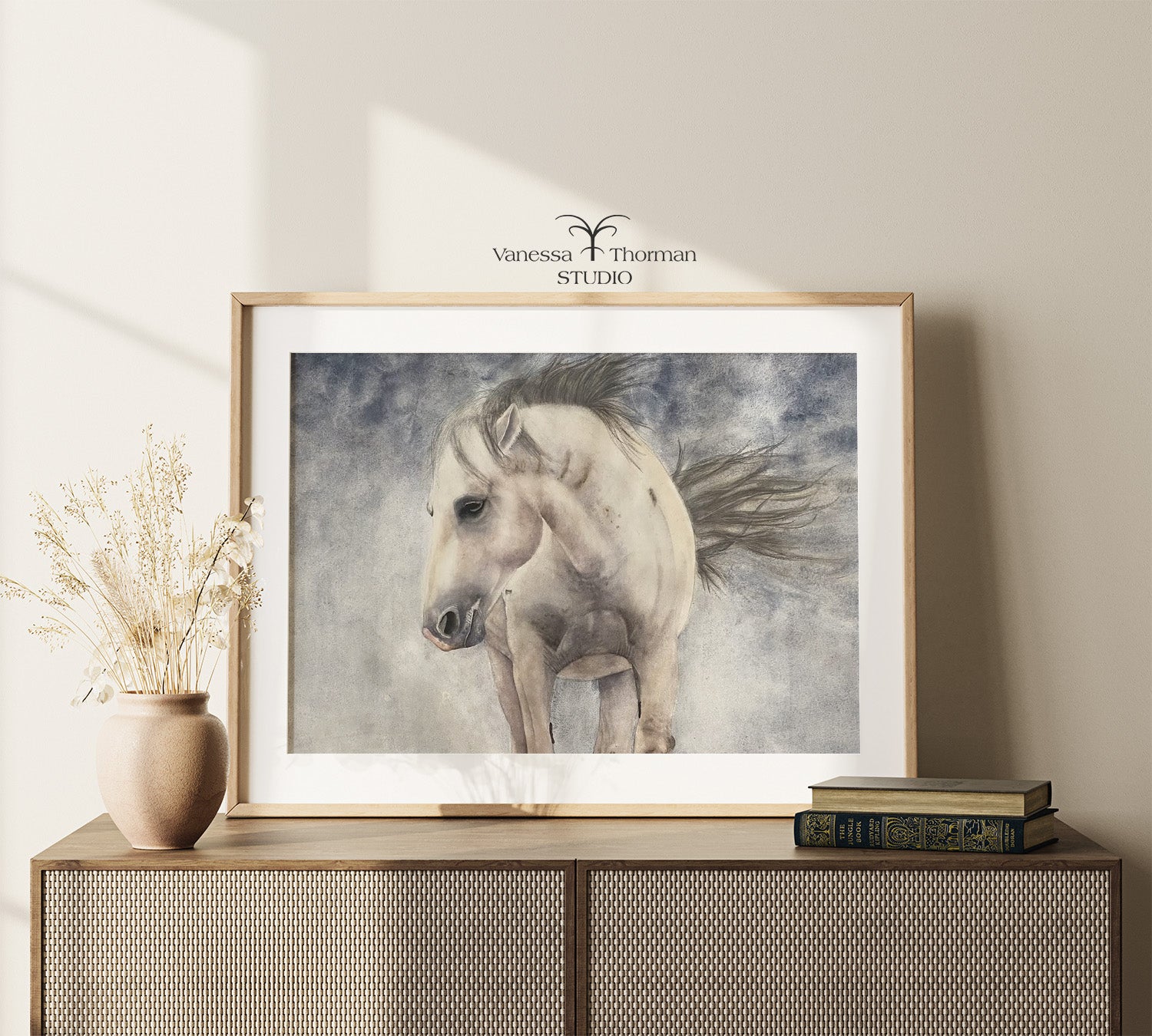 Framed horse watercolor art print on a blue stormy background on a console table
